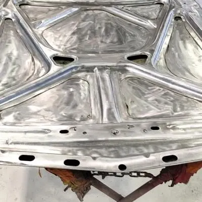 Underside of the bonnet in bare metal, showing the inner bracing