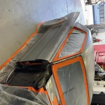 Rear of the Mustang in bare metal, masked with orange tape ready for primer