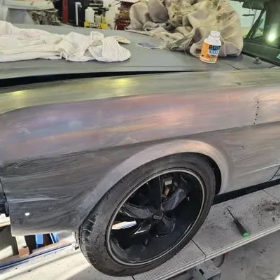 Rear wheel arch and quarter panel blocked smooth in bare metal
