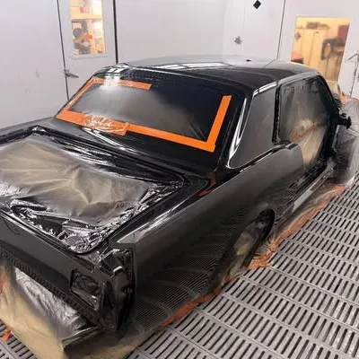Roof and rear of the Mustang in fresh gloss black in the spray booth, glass masked