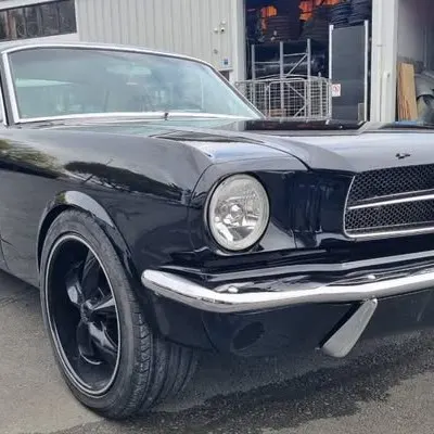 Close-up of the front corner, showing the mirror finish on the black paint